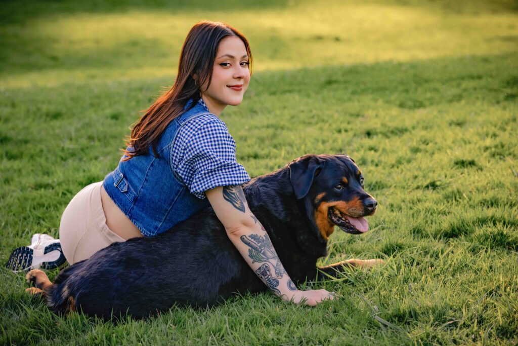 Woman and dog cuddling in park 