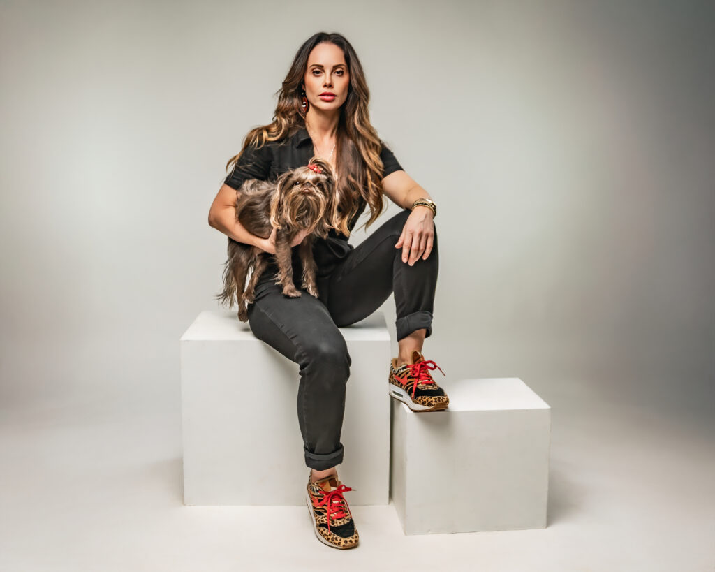 Woma and dog posing for portraits sitting on blocks