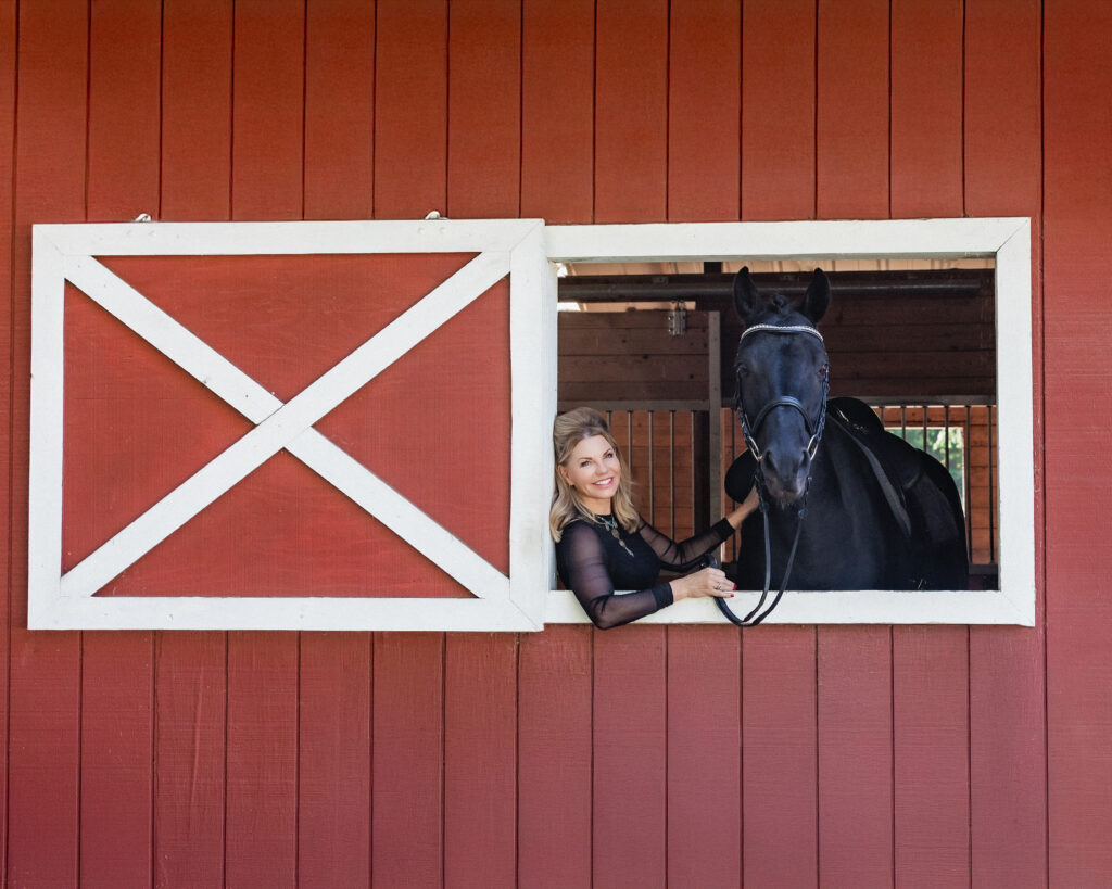 Woman in barn with horse